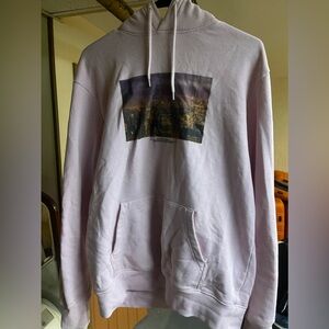 Pink hoodie with New York City backdrop